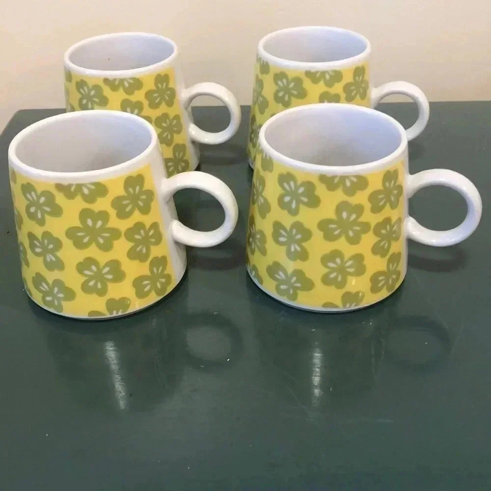 Vintage 1970s green and yellow flowers mugs with loop handles. Set of four.